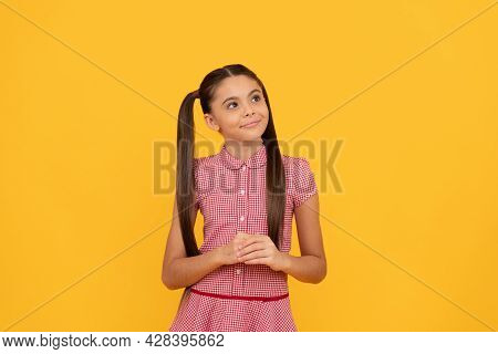 Dreamful School Age Girl Child With Pensive Look Fantasize About Something Yellow Background, Dreame