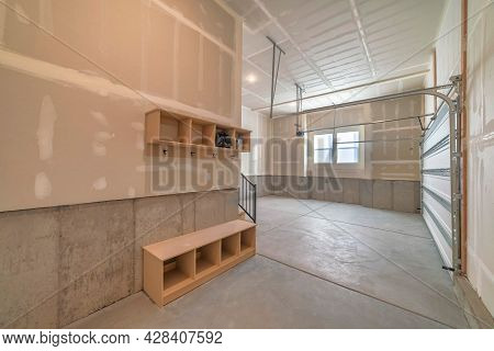 Unfinished Garage Door Interior With Mudroom And Windows