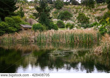 Bird-watching Hut Next To The Lake And Amongst The Reeds In Berwick Botanical Gardens