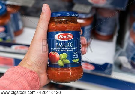 Tyumen, Russia-june 08, 2021: Barilla Basilico Sauce In Hand. Buying Products In A Hypermarket