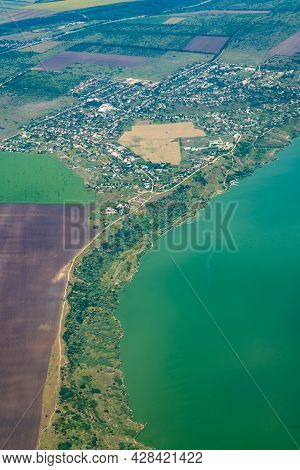 Land View Through The Airplane Window. Fields, Roads, Rivers From A Bird's Eye View. Porthole. Look
