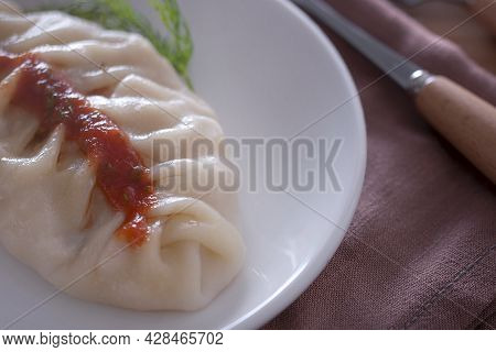 Delicious, Healthy Dish. Steamed Dumplings Drenched In Sauce.