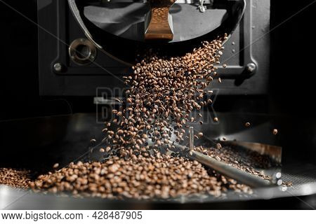 Coffee Processing. Roastery, Roasting Machine And Fresh Beans