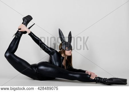 Sexy Beautiful Woman Pole Dancer Posing In Latex Costume On Background. Easter Bunny Concept.