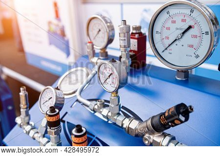Monometers Of Different Sizes On A Light Background