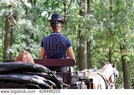Cabman Girl Carries A Passenger In A Horse Carriage In Summer Park. Travel And Transport In Past Cen