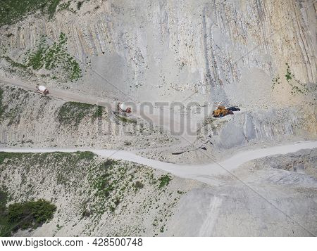 Many Industrial Excavators, Earthmoving Machines Extract Cement And Marl Rock In The Mountains Of No