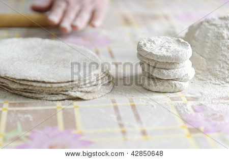Woman with a rolling for Karelian pies