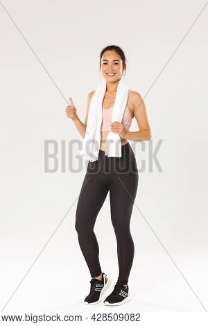 Sport, Gym And Healthy Body Concept. Full Length Of Satisfied Smiling Female Athlete, Cute Asian Gir