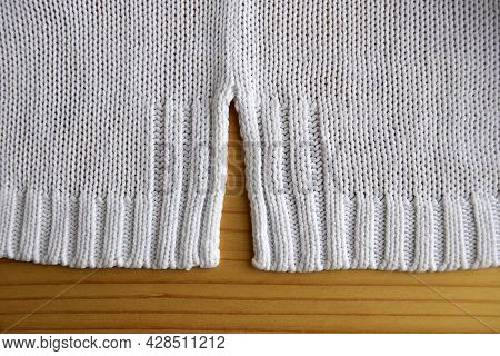 Knitted Fabric Structure From White Thread.  The Edge Of The Product, Fragment.  Handmade  Knitted R