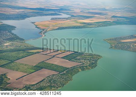 Land View Through The Airplane Window. Fields, Roads, Rivers From A Bird's Eye View. Porthole. Look