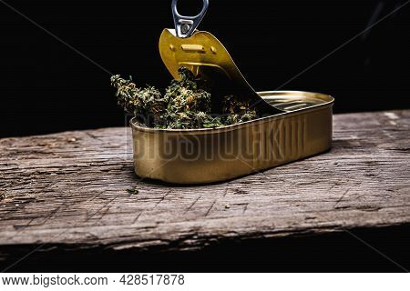 Cannabis In A Open Tin Can. On Old Wooden Background. Rustic. Horizontal Orintation