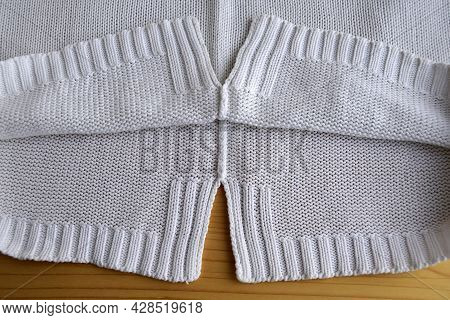 Knitted Fabric Structure From White Thread.  The Edge Of The Product, Fragment.  Handmade  Knitted R