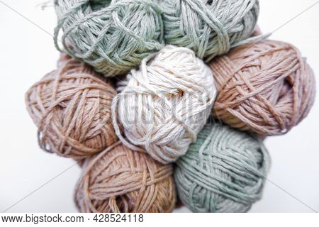 Yarn In A Knitted Basket On A White Background With Hooks. Yarn Of Different Colors. The Concept Of 