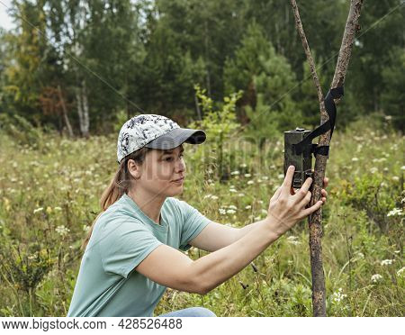 Young Woman Scientist Biologist Zoologist Sets Camera Trap For Observing Wild Animals In Summer Taig