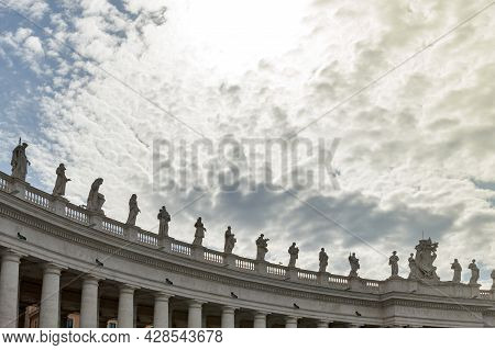 Details Of The Entablature With Statues Of Religious Saints On The Colonnades Of St. Peter's Basilic