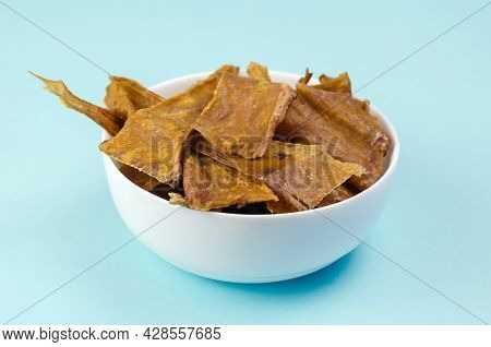 Fragrant Training Treats For Pets On Blue Background. Natural Air Dried Dog Treats In A White Cerami