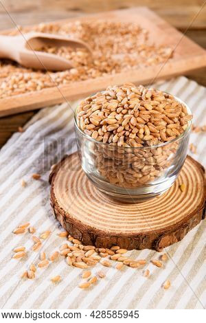 Wholegrain Uncooked Raw Spelt Farro In Glass Bowl On The Wooden Background