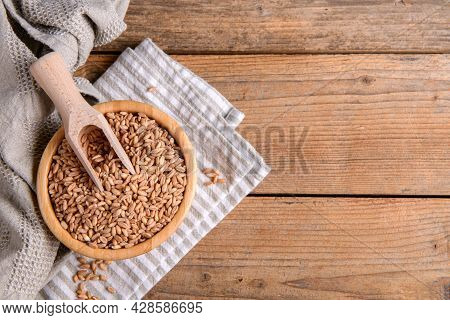 Wholegrain Uncooked Raw Spelt Farro In Bowl On The Wooden Background