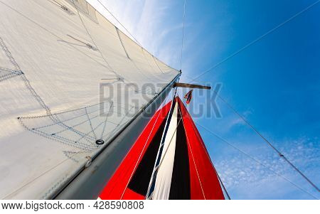 Spinnaker With Uphaul On Sail Boat, Blue Sky In Background. Marine Sailing Objects Concept.