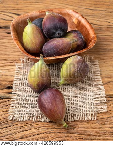 Figs In A Bowl Over Wooden Table. Short Depth Of Field.