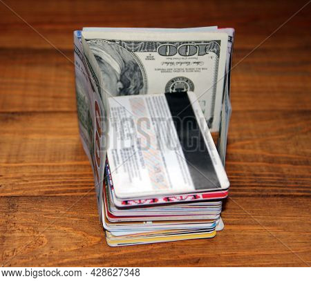 Hundred Dollar Notes And Credit Cards. Pile Of Credit Cards In Dollars. Cash And Non-cash Money. Pla