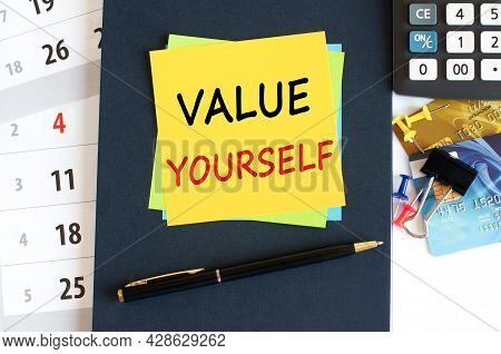 Value Yourself, Text On Yellow Paper Square Shape On A Blue Background. Notepad, Calculator, Credit 