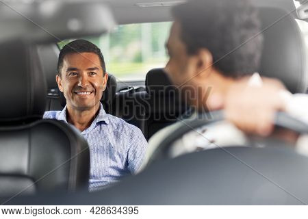 transportation, vehicle and people concept - happy smiling middle aged male passenger talking to taxi car driver