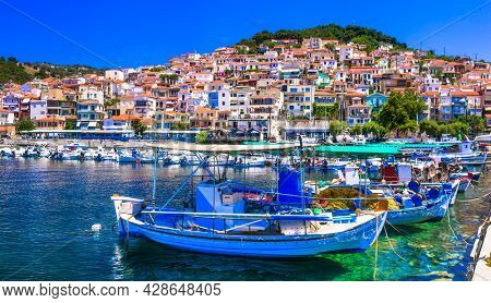 Traditional colorful Greece  - charming Plomari town. Fishing boats in the port, Lesvos island, Eastern Sporades