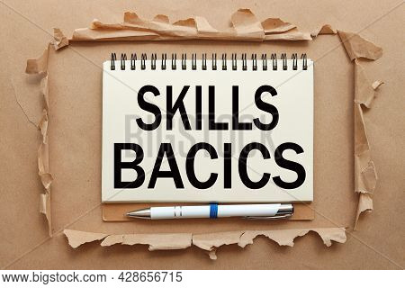 Skills Bacics. Text On Notepad Near Torn Paper