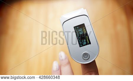 Pulse Oximeter On Finger Showing Oxygen Saturation And Heart Rate. Prevention Of Hypoxia In Pneumoni