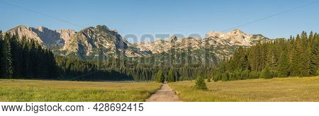 Big panorma of Durmitor mountains in Zabljak, Montenegro. Sunny summer morning in Durmitor National Park. Montenegro countryside with beautiful mountains range near the Zabljak town