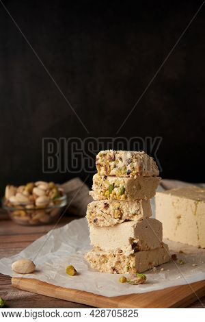 Organic Halva With Pistachios On A Wooden Surface. Traditional Middle Eastern Sweets. Jewish, turkis