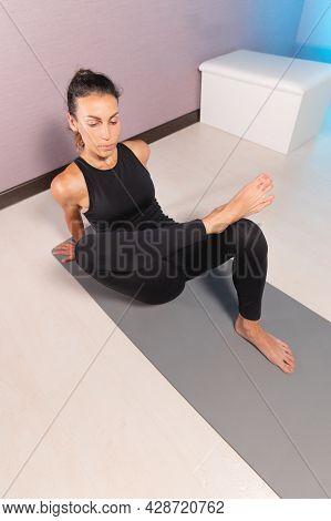 Sporty Slim Caucasian Woman Doing Self Massage On Fitness Mat With Massage Ball Indoors. Self-isolat