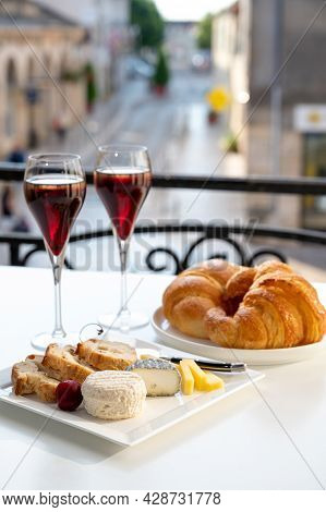 Drinking Of Kir Royal,  French Aperitif Cocktail Made  From Creme De Cassis Topped With Champagne, T