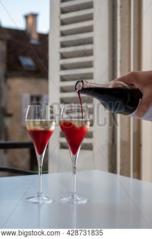 Drinking Of Kir Royal,  French Aperitif Cocktail Made  From Creme De Cassis Topped With Champagne, T