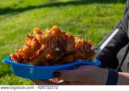 Eating Of Diep-fried Cod Fish Pieces Served With Remoulade Sauce