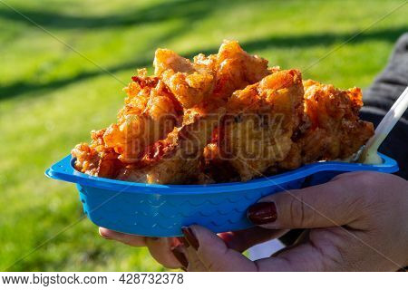 Eating Of Diep-fried Cod Fish Pieces Served With Remoulade Sauce
