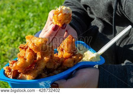 Eating Of Diep-fried Cod Fish Pieces Served With Remoulade Sauce