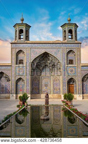 Shiraz, Iran - May 2019: Iranian Woman Standing By The Pool Of Nasir Al-mulk Mosque During Sunset. N