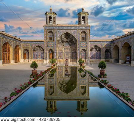 Shiraz, Iran - May 2019: Iranian Woman Standing By The Pool Of Nasir Al-mulk Mosque During Sunset. N