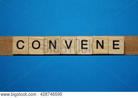 Gray Word Convene In Small Square Wooden Letters With Black Font On A Blue Background