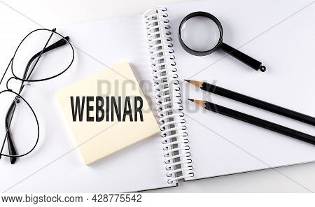 Word Webinar On The Sicker On Notebook With Pencils,magnifier And Glasses