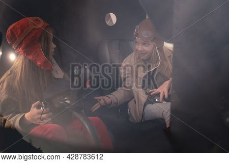 Emotional Preteen Girl Talking To Female Friend In Helicopter Cockpit