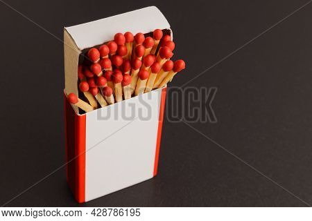 An Open Matchbox With A Blank White Label On A Black Background. Soft Focus.