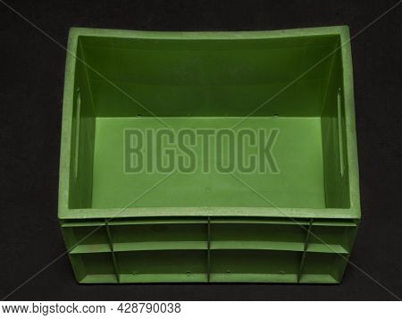 Empty Green Plastic Box For Transporting Food, Milk In Production Warehouses. Close-up Photo, On A B
