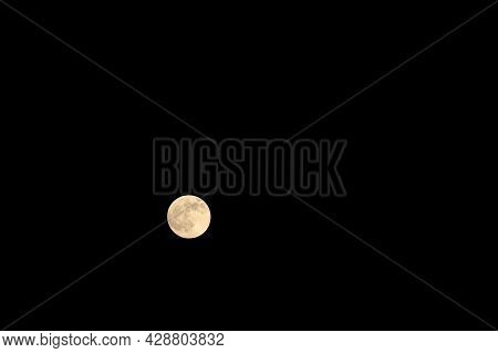 Dark And Almost Black Sky With A Bright Moon.