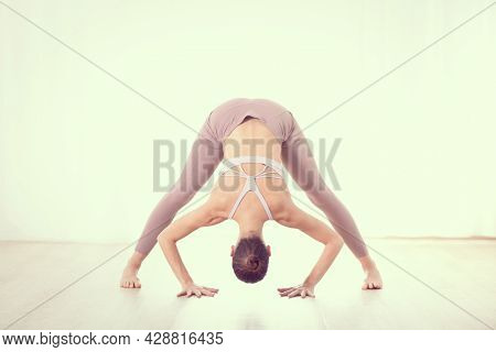 Portrait Of Gorgeous Active Sporty Young Woman Practicing Yoga In Studio. Beautiful Girl Practice Da