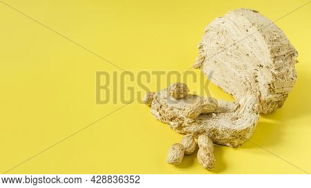 Peanut Halva With Peanut Decor On The Bright Yellow Background Of The Mine Space. Halva Of Oriental 