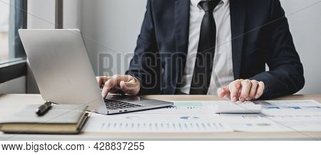Man Using Laptop And Pressing Calculator, Business Man Sitting In Private Office At His Company, He 